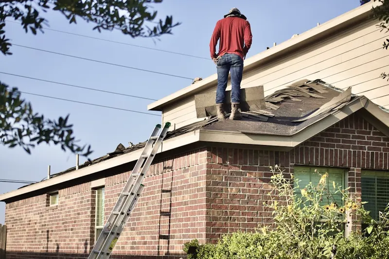 Professional roofer working on a residential roof in Carl